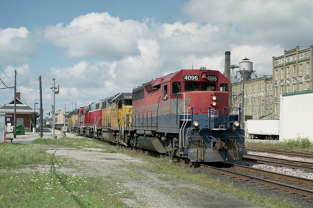 Hard to believe the GEXR is no longer thru here. The road's time came and went rather quickly. For this shot, I have wandered up that way on a Saturday, a rare occasion for me because I rather liked working weekends. Nice combination of power, rolling east: RLK 4096, LLPX 2236, GEXR 3835, RLK 2210 and LLPX 2210. VIA station on left.
(Yes, not a typo: the last two engines featured the same number...but not for long)
