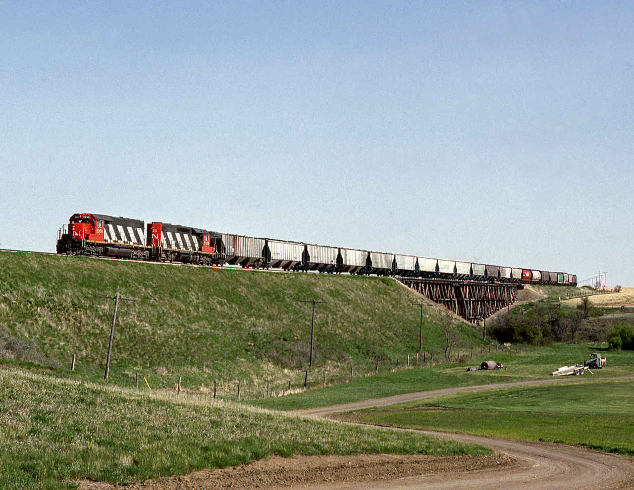 CN's Avonlea Subdivision wayfreight just out of Moose Jaw makes the 3rd crossing of the Moose Jaw Creek across from CFB Moose Jaw air base home of the Snowbirds