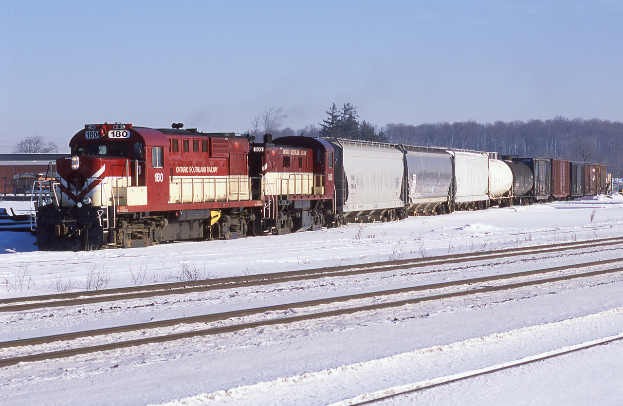On January 30th 2003, OSRX 180 still looks quite clean from it's recent paint job as it and the 503 do some switching around the junction before grabbing the van and heading to Guelph.