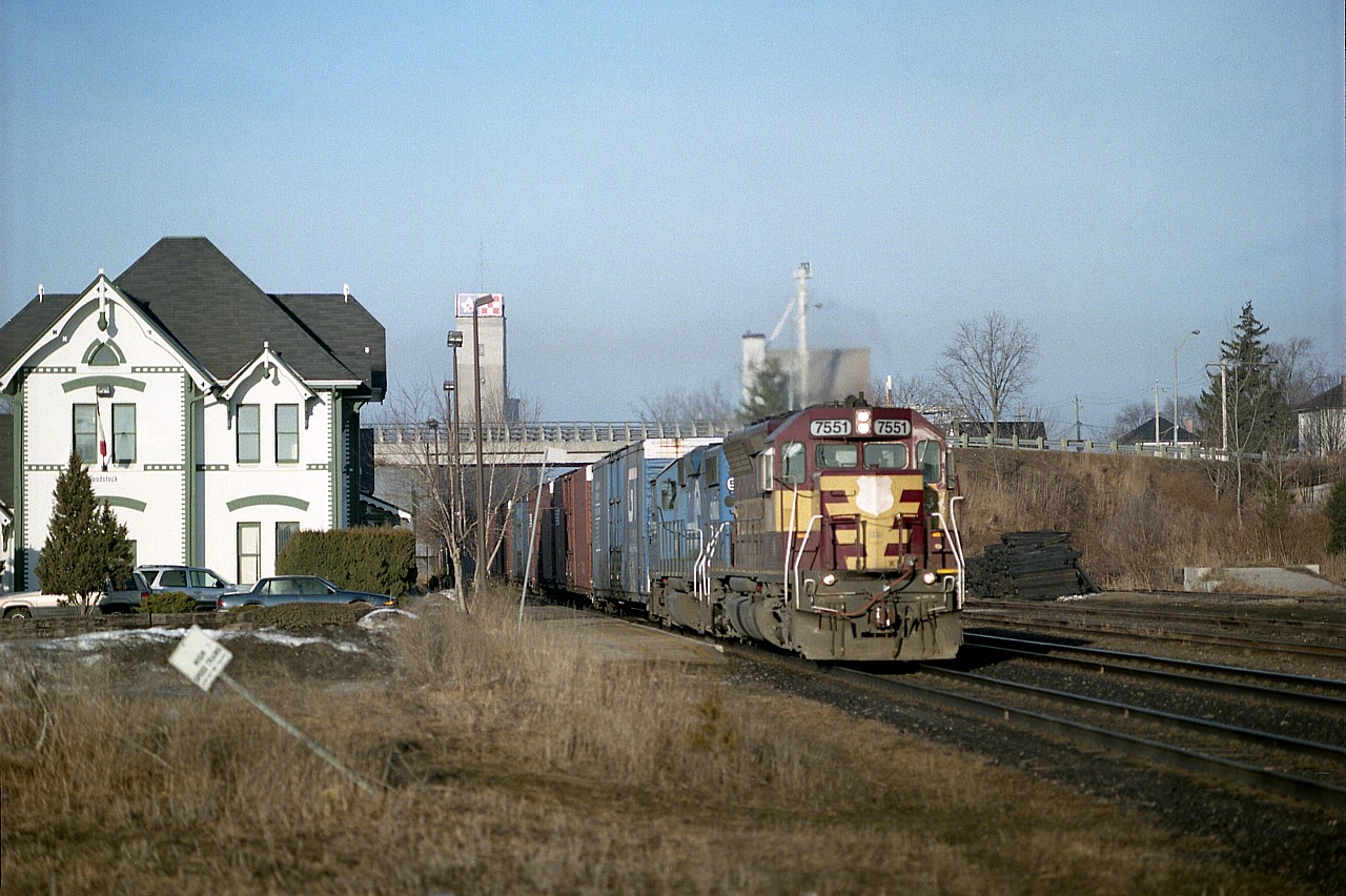 I sure miss the autoparts train #328. It was always something to watch for. These days, though, with the communications network of the railfan, there would be no surprise left by the time it got as far as Niagara.:o)
So here we have, in appearance at least, WC 7551, CR 5336 eastbound passing the Woodstock station on a bright and early Tuesday morning. Thats WC and CR on an NS train on CN. Now I am wondering if there are any active locomotives out there still in Wisconsin Central paint. Haven't seen one in ages.
For those who take an interest, this image is from a medium format negative, not digital, not slide. Not bad.