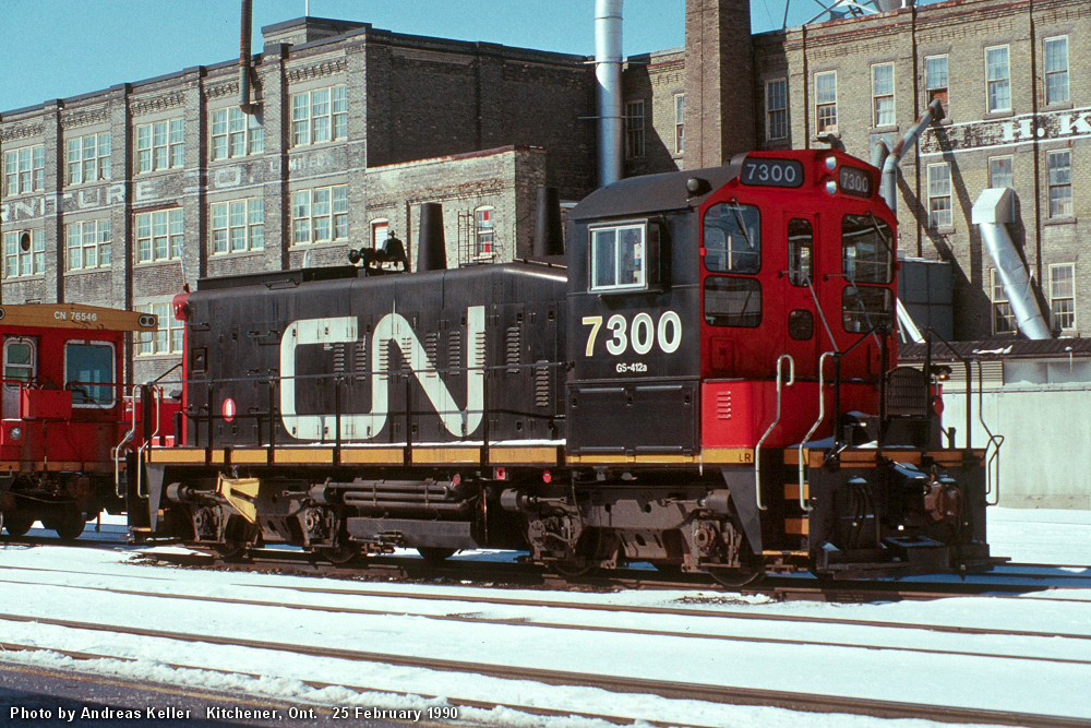 CN EMD SW1200RSm 7300 awaits assignment at Kitchener on February 25th, 1990. Built as CN 1382 in April 1960, it currently resides at Exporail in green and gold paint with its as delivered number