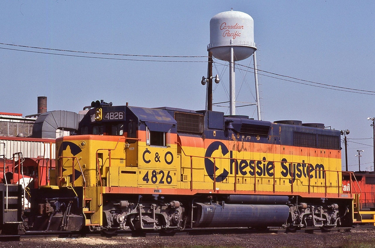In a sea of action red & multimarks, one of my favourite liveries, officially 'lived' 14  years.


 Chessie System, C & O  #4826, one of ten GP38, EMD 1970, under the 'gaze' of that 'script' water tower.


 At CP Rail Agincourt, May 6, 1984 Kodachrome by S.Danko


 noteworthy


 CP and C&O had a long standing motive power arrangement. My first visit to CP Leaside, on a sunny Sunday morning spring 1968, the first two trains, one east one west were powered by C&O / B&O  F  units. (That westbound had an A-B-A lashup). 


 Four years later ( 1972 )  the Chessie System livery was unveiled 


   Chessie System era officially ended July 1, 1986  when  the   C  &  O  merged into CSX Transportation


   CSX Corporation, dates from November 1, 1980,  when Chessie  &  Family Lines  agreed to  form that holding company 


   ( only months before the Chessie era ended, April 1986,  the  B  &  O officially merged into C & O; nothwithstanding the latter's original purchase of the B&O was 1963 ) 


  that sea  


 sdfourty