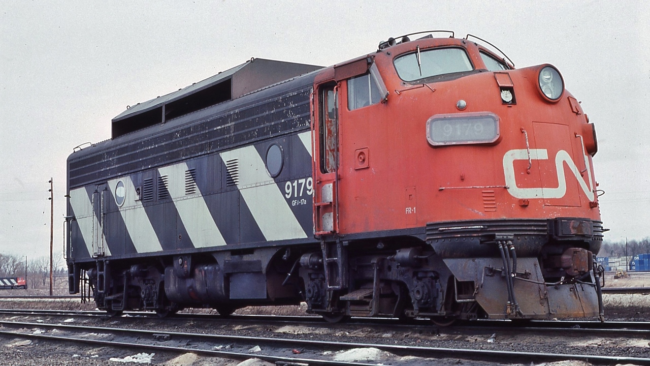 the snow shield provides a strange look....effective ?
 

  a 1952 GMD product the F7A was rebuilt 1972 to F7Au class CFA-17a, retired by 1989


 at Mac Yard, March 8, 1981 Kodachrome by S. Danko


 interesting:
 

 background far left, that is a M420
 

 snow shield in service  


 sans snow shield  
 

 CN sister w/red snow shield  
 

 sdfourty