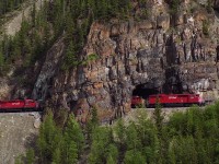 Coming down The Big Hill, SD40-2F 9000 leads a long train through the short tunnel at Mount Stephen, June 1990.