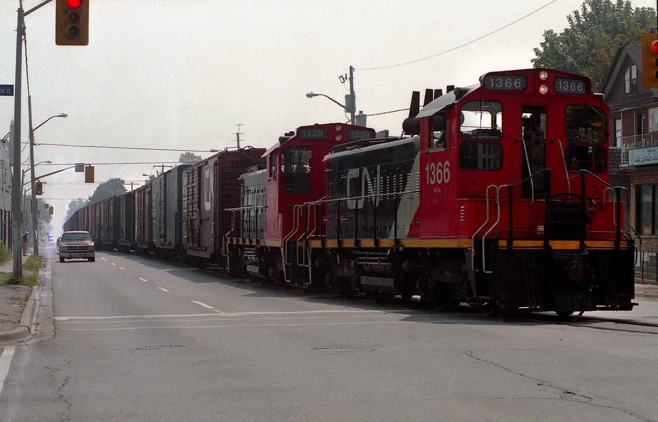 Running north on Ritson Road, mile 1.9 of the Oshawa Railway, SW1200RS 1366 and 1339 run the red light at Bond Street as they approach the General Motors North Plant.  Unfortunately, I didn't note the date I shot the photo, but the rails were removed in 1988.