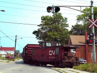 Just make a right when you get to Bruce Street... a member of the crew keeps  watch as a train hauling a string of 50 foot boxcars for the GM North Plant in Oshawa negotiates the 5 mph curve turning east onto Bruce Street not long before the plant was closed.