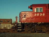 On the north side of the tracks, across from the restored TH&B Smithville station stood a handsome brick building from the, I'm guessing, the 1930's.  A Hamilton bound freight, led by GP38-2 3038, runs through.