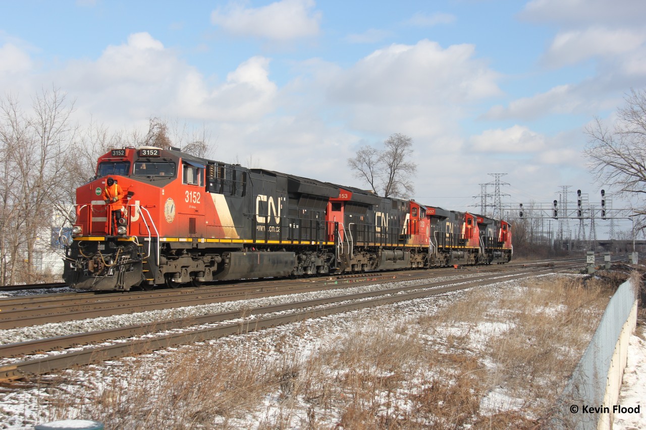 The power for CN 422 pulls ahead of the switch to back onto its train. At least an almost matching set of GEs is not bad. Of note is the black patch on the 3152 and the crew member properly prepared for the bitterly cold conditions. Another busy few hours at Aldershot: CN 570 just left, this train switching, 396 coming up beside, and 435 to the east waiting to enter Aldershot.