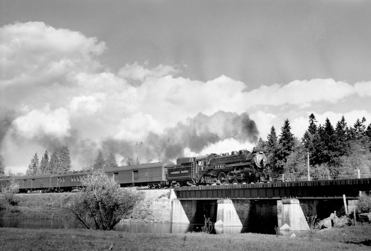 Train no. 2 with engine 2701 and 10 cars crossing Kanaka creek bridge near Haney.  By this time, my dad was  using light yellow filters to make the clouds and sky more dramatic.