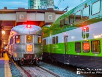 <b>When you have the chance, GO.</b> Amtrak 63/VIA Rail Canada 98 (Maple Leaf) has just arrived at Union Station in Toronto, Ontario on the evening of Tuesday, August 28, 2018 with former New York Central Railroad Budd built Pullman obs/diner/sleeper "Babbling Brook" (WEBX 800007) holding the markers. Although the car would make a quick turn, presently Amtrak service to Canada is listed as "cancelled until further notice" due to COVID-19 related travel restrictions, and it is a reminder to not to take any rail travel for granted. A GO Transit car frames the scene and provides a reflection of the "New England States" tail sign.