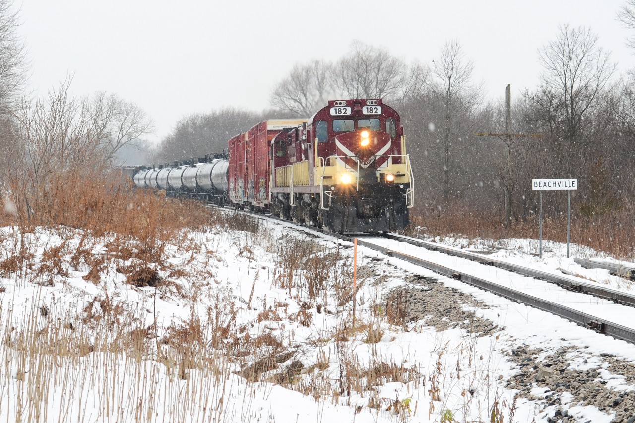 In the midst of a snow storm which brightened the day up briefly, OSR 182 and 181 curve out of Beachville passing the namesake mile board with a lengthly train for CP in Woodstock. MLW’s in a fresh snow storm is sweet in this era, iconic Canadian scene.