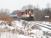  In the midst of a snow storm which brightened the day up briefly, OSR 182 and 181 curve out of Beachville passing the namesake mile board with a lengthly train for CP in Woodstock. MLW’s in a fresh snow storm is sweet in this era, iconic Canadian scene.