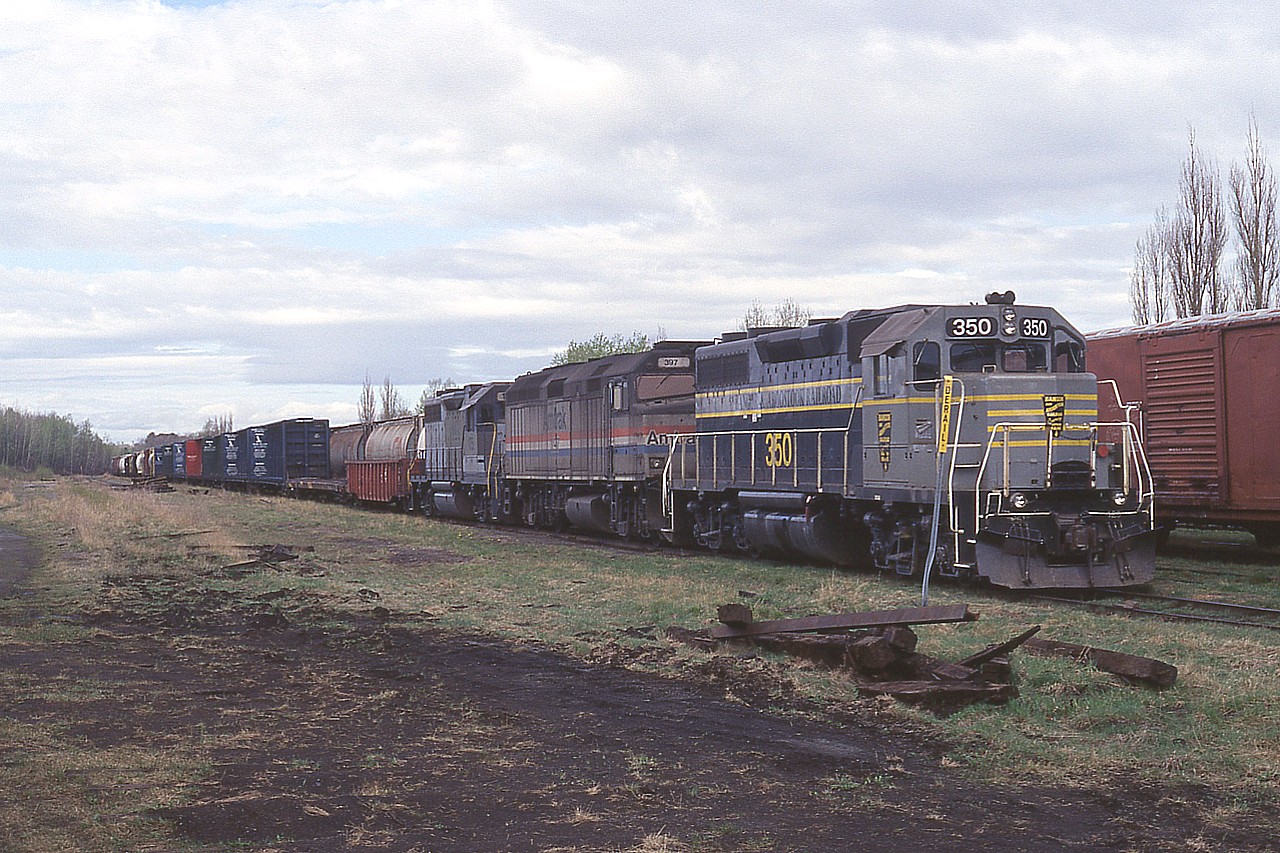 The old Canadian American Railroad. From 1994 to its bankrupt end in 2002. Really, there is no other collection of railroads in Canada in my mind as confusing as this bunch.
CDAC operated former CP lines between Lennoxville Quebec and Brownsville, Maine, beginning in 1994. The Quebec Southern operated former CP lines between Montreal and Lennoxville, beginning in 1996; same year as Northern Vermont took over operations running from CPs line south from Brookport, Quebec into Vermont. It became under the Bangor & Aroostook System as well; all of this owned by a holding company called Iron Road Rwys. Confused?
Anyway, the conglomerate built up business rather intensively, but neglected the physical plant to a degree that deferred maintenance eventually led to bankruptcy in 2001 and in 2002 it was all taken over by Montreal, Maine and Atlantic (MM&A...Yes, the Lac Megantic tragedy) 
Anyway, seen here is (CDAC) BAR 350 (formerly BAR 81), Amttrak 397 (leased ??) and HATX 176 (leased) rolling thru some rather unkempt right of way. The GPS location indicated is only approximate.