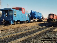 A busy morning at the Galt depot finds BAWX caboose 79788, which is former CN 79788, viewed after being shoved around the west leg of the wye in Galt along with a freshly constructed dimensional load by CP GP9u 8239. The caboose and large load originated from the nearby Babcock & Wilcox facility on the Waterloo Subdvision. Also idling in Galt were CP 5913 and CP 776, while according to notes train 270 also was working with 5409 and 6407. 
<br>
Twenty-six years later and the Babcock & Wilcox facility was still manufacturing large components and is currently regularly serviced by CP.