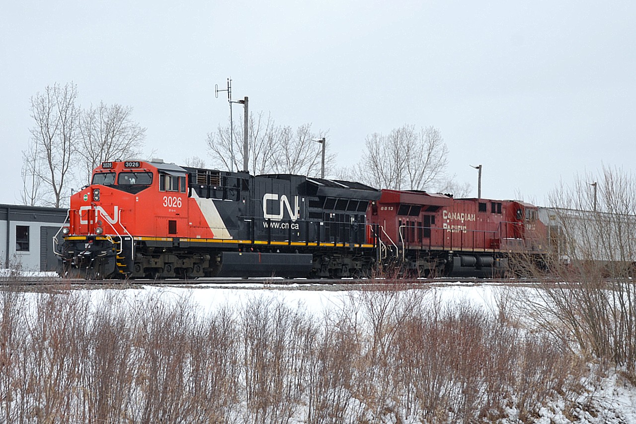 I heard that CP #246 today was going to be heading down the Niagara area with a CN as trailing unit. It was a blustery cold and windy day today and I was not in the mood to head out to wait anywhere for this particular train.  Perhaps the CN will be leading tomorrow Feb 6th as train #247? Not to worry. If it does, this is what it will look like.  CN 3026 and CP 8813 stopped at the Welland Yard office as train #255 close to three years ago. There. I have just saved a trip to Welland. :o)