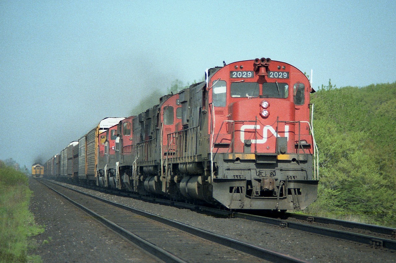 While out on a day off; just 'cruising' the Dundas sub; came across this eastbound freight. Moving very slowly, as it looks as if someone is addressing a problem down on the third unit.  The Budds westbound have just one by.
Power consist is CN 2029, 2025, 2564, 9464 and 9501. I found it interesting it is still not ribbon rail on the track it occupies.