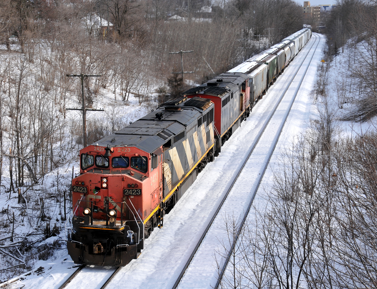 A43531 05 thunders out of Brantford with CN 2423 and CN 2438 at the helm. These two aging C40-8M's were putting up quite the fight with their 155 car train