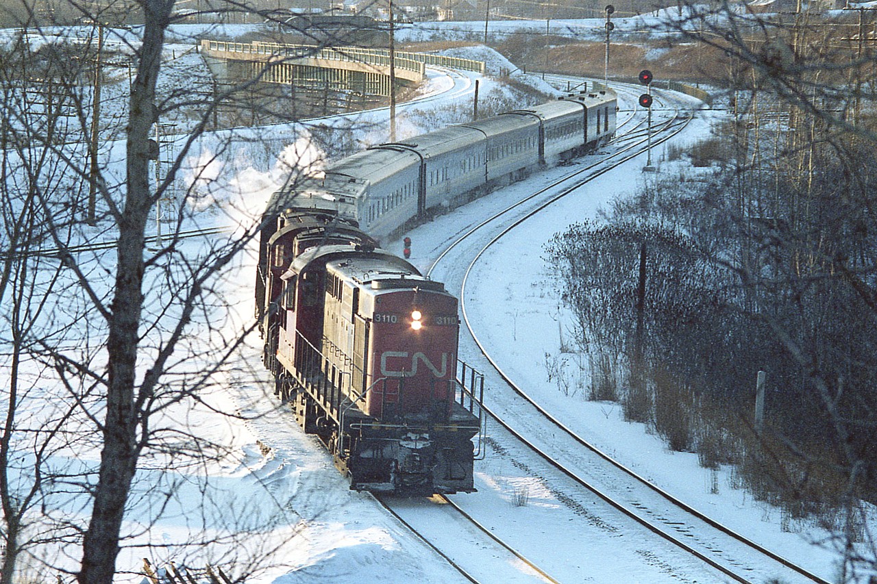 This looks like a frigid afternoon. Much like the day I am posting this.  Judging by the low sun in the western sky, I am going with the idea this is train #86, which was due in at Aldershot at 1614. But do not know for sure.
A pair of old RS-18s, 3110 and 3106 are seen from the railfans hillside chugging downgrade into Bayivew Jct. Not exactly classy, but they got the job done.