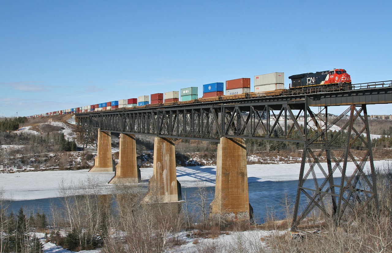 Prince Rupert to Stevens Point Wisconsin, train Q 18451 19 rolls soars above the North Saskatchewan River, as they depart Edmonton, Alberta with a 9779 foot train.