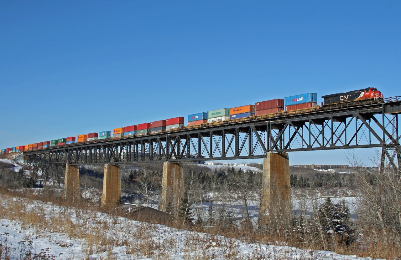 Calgary to Vancouver train CN Q 14751 02 soars above the North Saskatchewan River with CN 3057, CN 3858 operating DP 1x0x1 with 153 cars