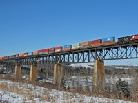 Calgary to Vancouver train CN Q 14751 02 soars above the North Saskatchewan River with CN 3057, CN 3858 operating DP 1x0x1 with 153 cars