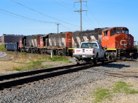 I was watching the CN crew pick up the blue gon out of AltaSteel (rusty red building in the background) and then get a light to come north towards me. Just as they head north this CP truck drives up and becomes part of the scene. You just cannot believe how things work out sometimes.