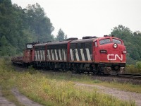  Late August 1986 was the very last time I witnessed the fan-favourite CN A-B-A combination on the Nanticoke Steel train #725. This edition features CN 9166, 9195 and 9177. The next time I had a chance to get out for it was Sept 2nd, and 4572 had subbed for 9177. Then by the 16th, 4520 subbed for 9195. Throughout September at least one or two of the old cab units were knocked out of the power consist. I guess this run took a toll on the old warriors.
 The view here is just before Dundas station, rather late in the afternoon. Too late for a chase. 