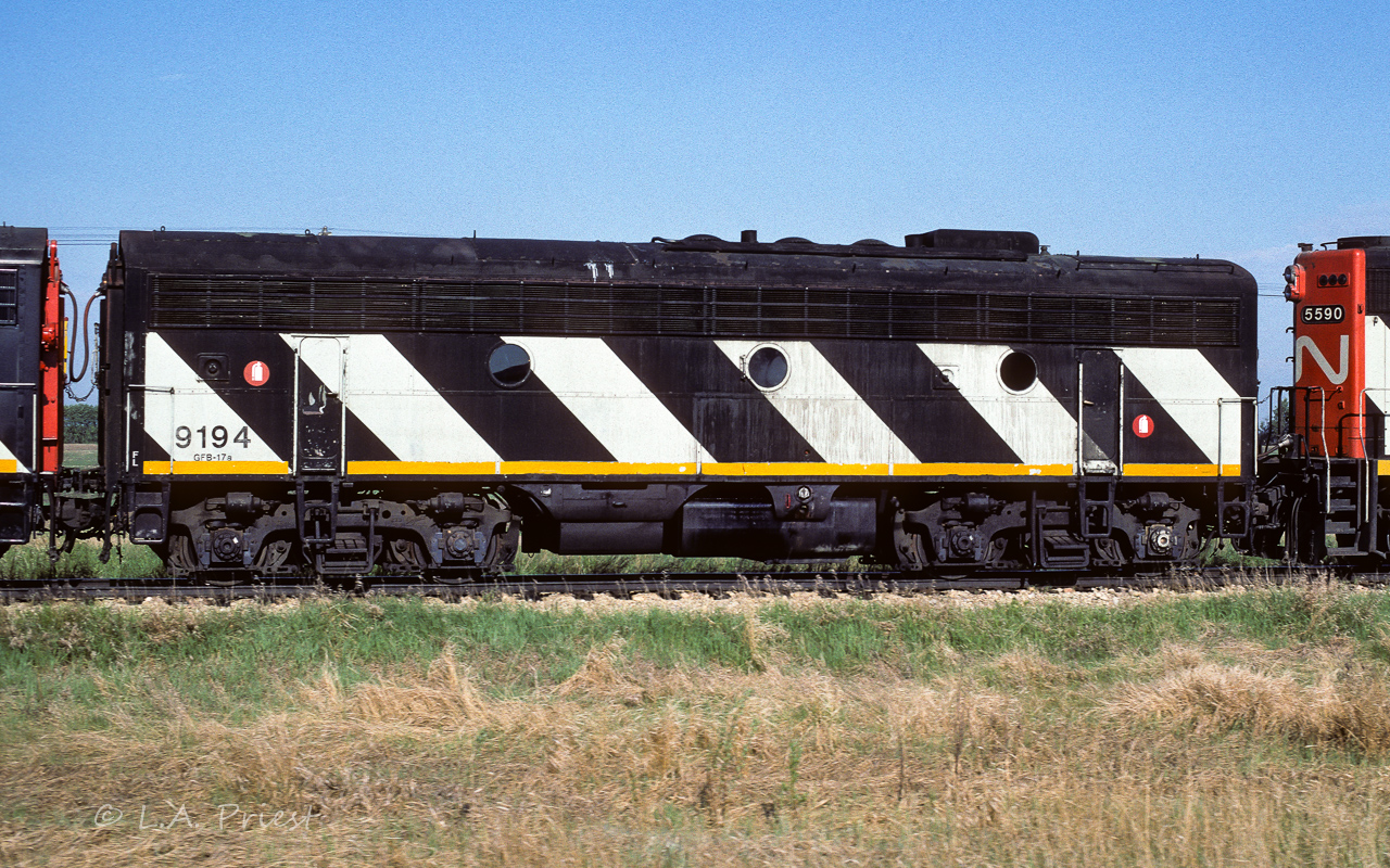 Roster shot of the 9194 taken on the fly north of Egremont. The complete lineup included the 5590, 9194, 9107 and 9159. For some reason the 9194 received a unique paint job (9194 in black letters) when compared to the other re-built F unit B's. More on this can be found in Vol.20, No.1 of the CNRHA magazine CN Lines, plus there is another photo of the 9194 showing the right side and how the zebra stripes are reversed (but with 9194 in white letters). Vol.20, No.2 of CN Lines has info for those that interested in modelling F units.