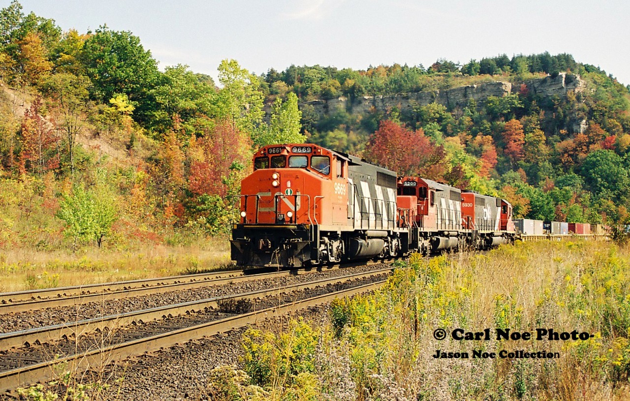 CN Laser 239 climbs up the grade through Dundas during an early fall day with a consist that included; 9669, 5200 and GTW 5900.
