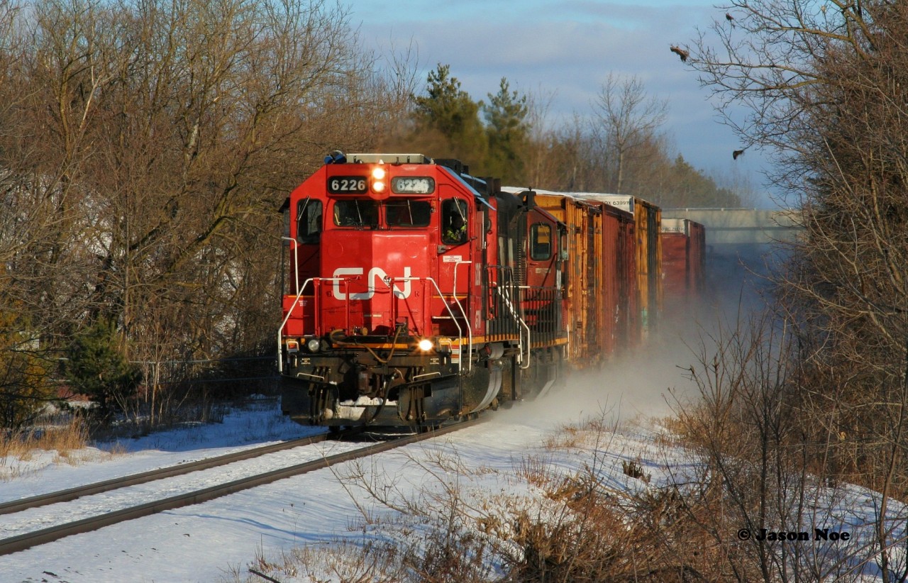 CN L540 is westbound in Breslau on the Guelph Subdivision as it returns to Kitchener after lifting several hoppers from the large P&H Mill at Shantz Station on their way back from Guelph. Powering the train is GTW 6226 and 4028. December 29, 2020.