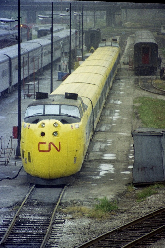 As the comment goes "Nothing to see here, Folks"............this could apply if you were watching trains back in 1976.....in Toronto.   This is just an image of CN's Turbo being serviced down in that big conglomerate of track, building and an old roundhouse ..........as seen from the Spadina bridge. Off to the right of this photo was a massive passenger coach yard.......all gone now.  Moved out to Mimico.
This shot to me is of something we once took for granted that is now a fading memory.