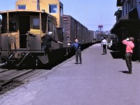 Railroading as it used to be!!!  A CP westbound freight passes the Sudbury, Ontario station on June 13, 1970.  The operator has already hooped up the orders to the tail end brakeman riding on the leading end of the caboose, the conductor is about to hand off the register ticket to the operator, the railroad police officer has decided that there is nothing out of the ordinary on the train, the other railroaders are contemplating getting back to work after the train passes, and finally, I have no idea who the other railfan was.  Simpler times.