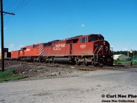 20 kilometers north of Sudbury situated along Highway 144 sits the small community of Cartier, Ontario. Here CP 418 with 9022 and 9024 is seen departing at the Spencer Avenue crossing after receiving a fresh crew as it heads toward Sudbury. 