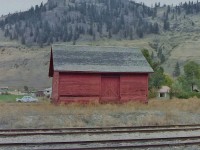 In response to a question asked by DAL (re picture 24912) I am attaching this picture of a stand alone wood frame freight shed at Midway BC. The building was located near the station but north of the main line. Using my past experience and taking an educated guess I would say foot print of the building would have been about 29ft x 29ft. It had two 6ft W freight doors (one each on the north & south sides) and had no man door or windows. The 8ft W platform ran the full length along the north side. If the building was built using CPR standard practices, the exterior walls would have been built using 10 ft long 2 inch x 6 inch wood studs spaced at 2 ft O.C. The finished floor elevation would met the CPR standard requirements for unloading railcars. The building had a crawl space under it. One thing I have always liked is to look at a railway building & picture it being used.