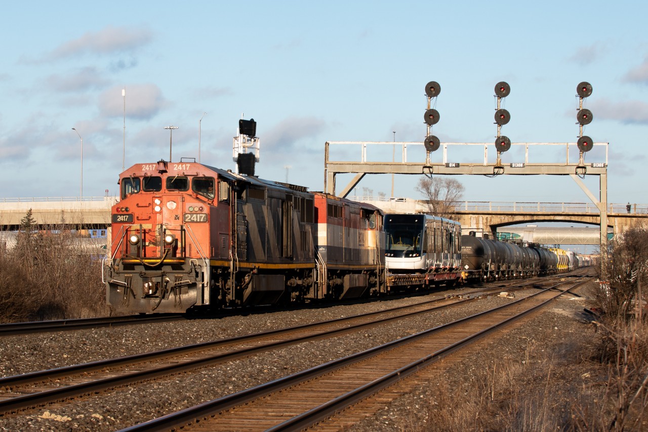 "Endangered"


As golden hour sets in on a frigid January day, a pair of veteran cowls take the lead of L517 as they enter the York Sub in Pickering, Ontario. Right behind the units is a brand new Bombardier Flexity LRT, built for the upcoming Eglinton Crosstown line. I presume it was returning from testing at the Bombardier facility out east.