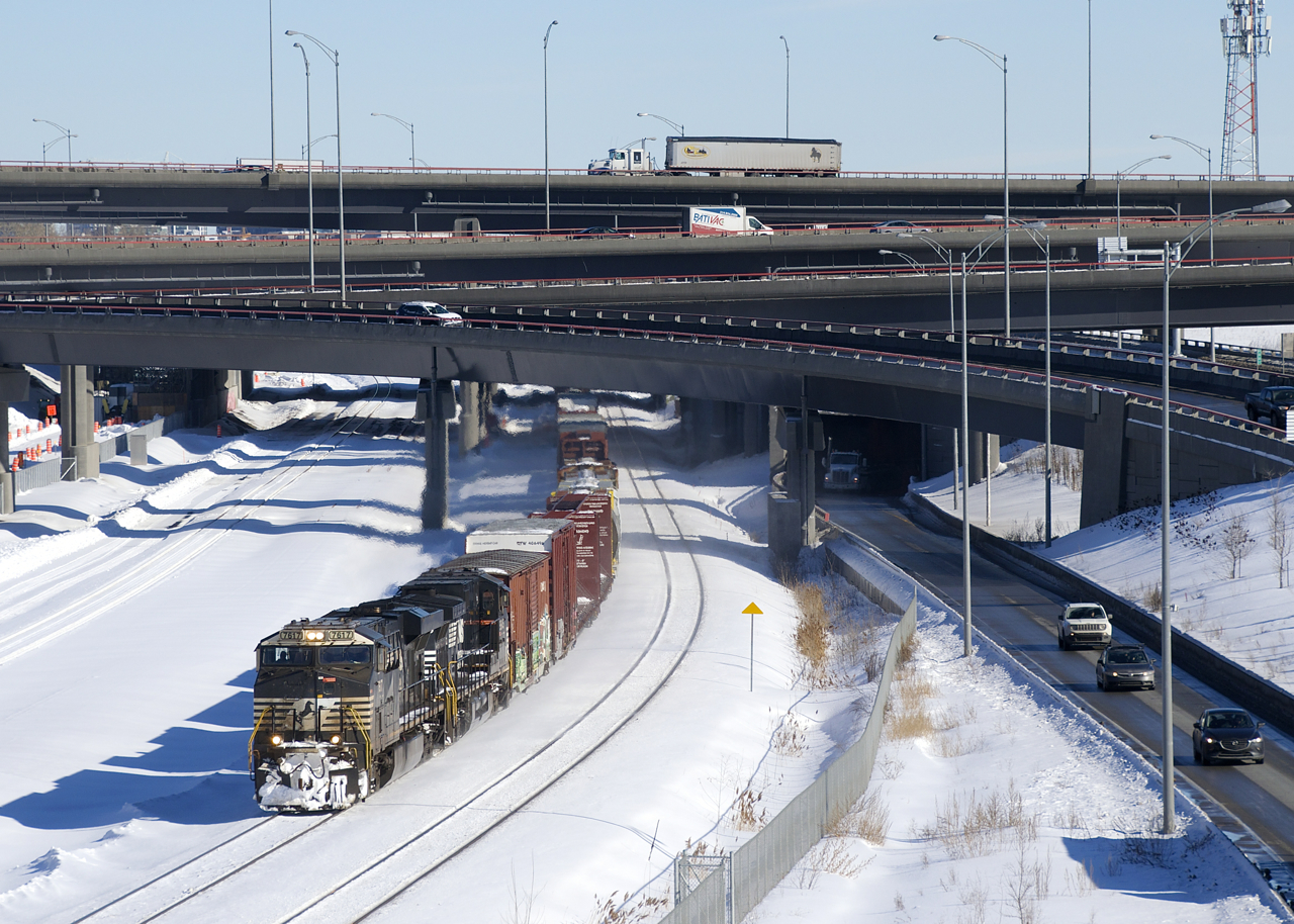 NS 7617 & NS 9845 lead a late CN 529 from out of the new Turcot interchange with 33 cars in tow.