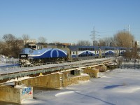AMT 1340 is leading EXO 1207 for Mascouche over the Lachine Canal on the frigid afternoon after a snowstorm hit Montreal. I'm standing on a snowbank that is about 7-8 feet high for some elevation.