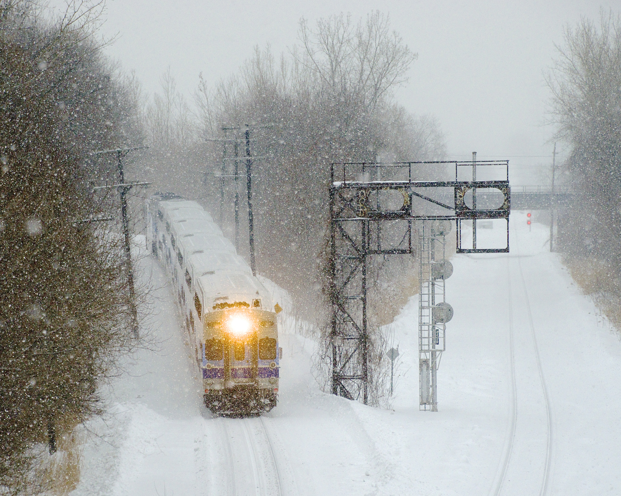 Bilevel cab car AMT 2002 leads EXO 185 as it drops down the North Jct lead, which connects the Westmount and the Adirondack Subs. This train has a consist of Bombardier Bilevel cars, which are not very common on the EXO network. They have only 22 bilevel cars, versus 160 Bombardier multilevel cars.