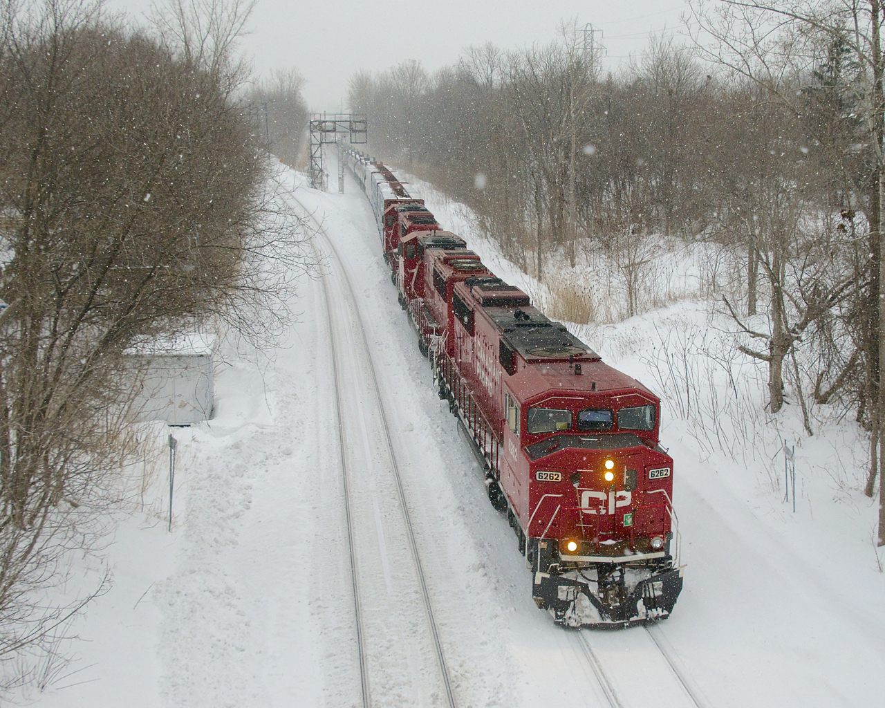 Snow is falling as CP 251 passes North Jct with an ex-SOO trio for power (CP 6262, CP 6252 & CP 6232).