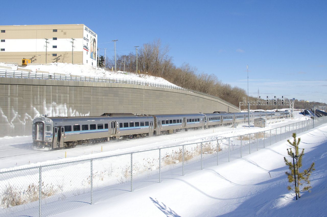 With the end of service on the electrified Deux-Montagnes commuter line and with the line already having been severed from the rest of the railway network last spring, the MR-90 cars that served on that line had to be trucked one at a time from Deux-Montagnes to Saint-Jérôme, where they were put back on rails. When enough cars accumulate, a train powered by an F59PHI is run and the cars head to the EXO yard in Pointe St-Charles. Here one of those moves is near the end of its run as it passes Turcot Ouest.