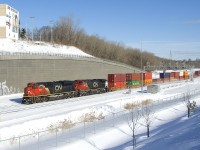Due to a derailment of CN 306 in New Brunswick, CN 120 is into Montreal much later than usual as it passes Turcot Ouest. This short edition of 121 (266 axles) has CN 8829 and CN 2587 up front and CN 2673 on the tail end.