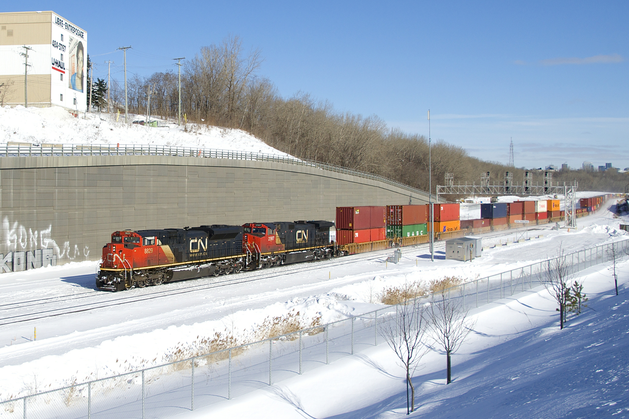 Due to a derailment of CN 306 in New Brunswick, CN 120 is into Montreal much later than usual as it passes Turcot Ouest. This short edition of 121 (266 axles) has CN 8829 and CN 2587 up front and CN 2673 on the tail end.