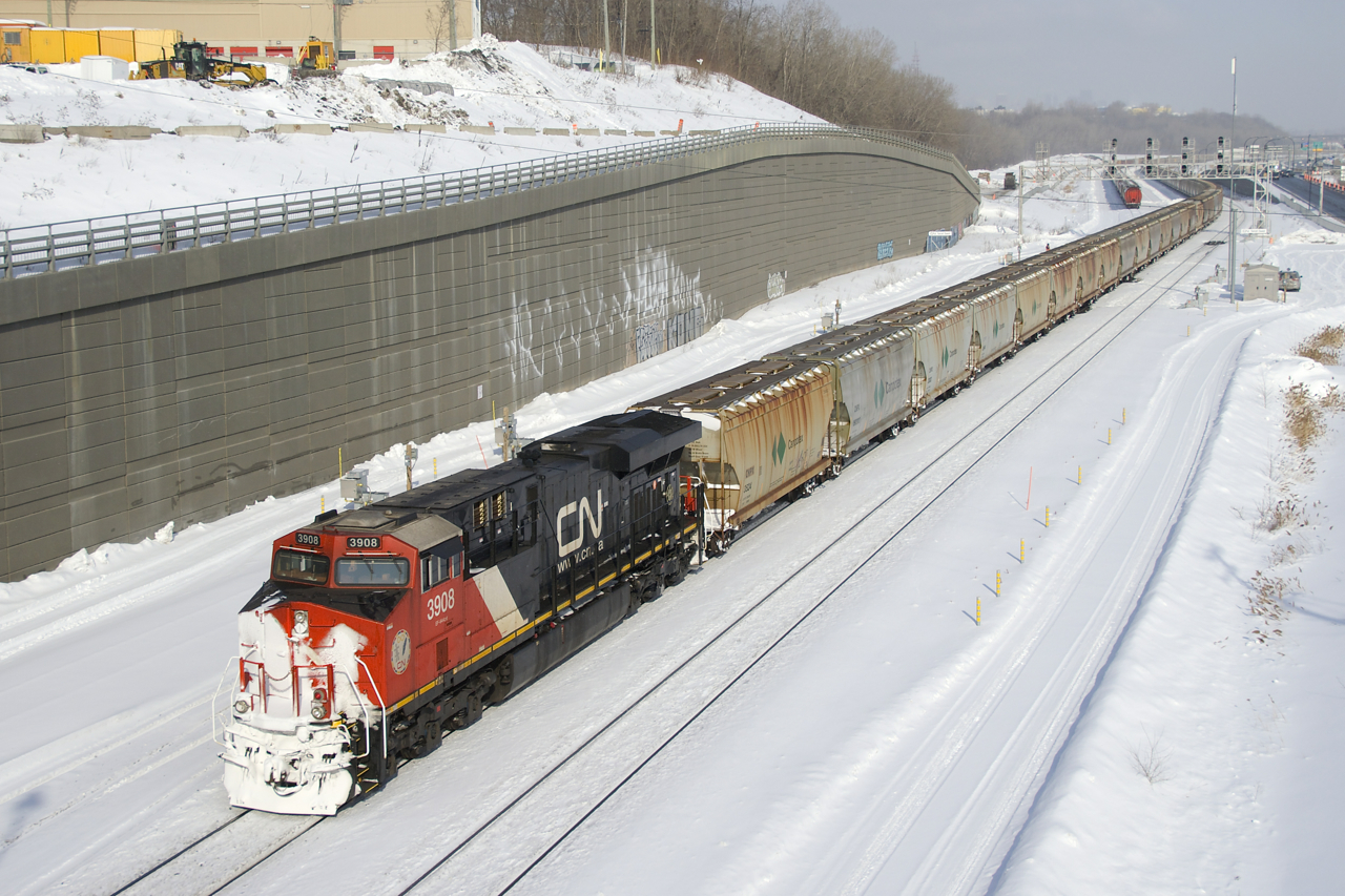Snow-covered CN 3908 brings up the rear of potash train CN B730 as it leaves Turcot Ouest with a new crew onboard. This 205-car train has CN 3816 and CN 2917 up front and CN 3055 mid-train.