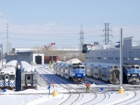 A crewmember is moving some blue flags in preparation for the trainsets at right to head to Central Station for the evening rush hour. AMT 1342 and AMT 1340 are leading two consists for the Mascouche line, between them is a consist for the Mont Saint-Hilaire line. At far left are an ex-GO Transit single level car and a line of Vickers gallery cars; supposedly they will be scrapped in the near future.
