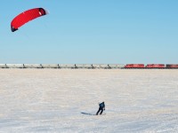 On a cold and clear winter evening, a second CP N08 makes it's way south toward Regina.  In the foreground, a kite skier makes great use of the snow covered fields and endless Saskatchewan winds. 
