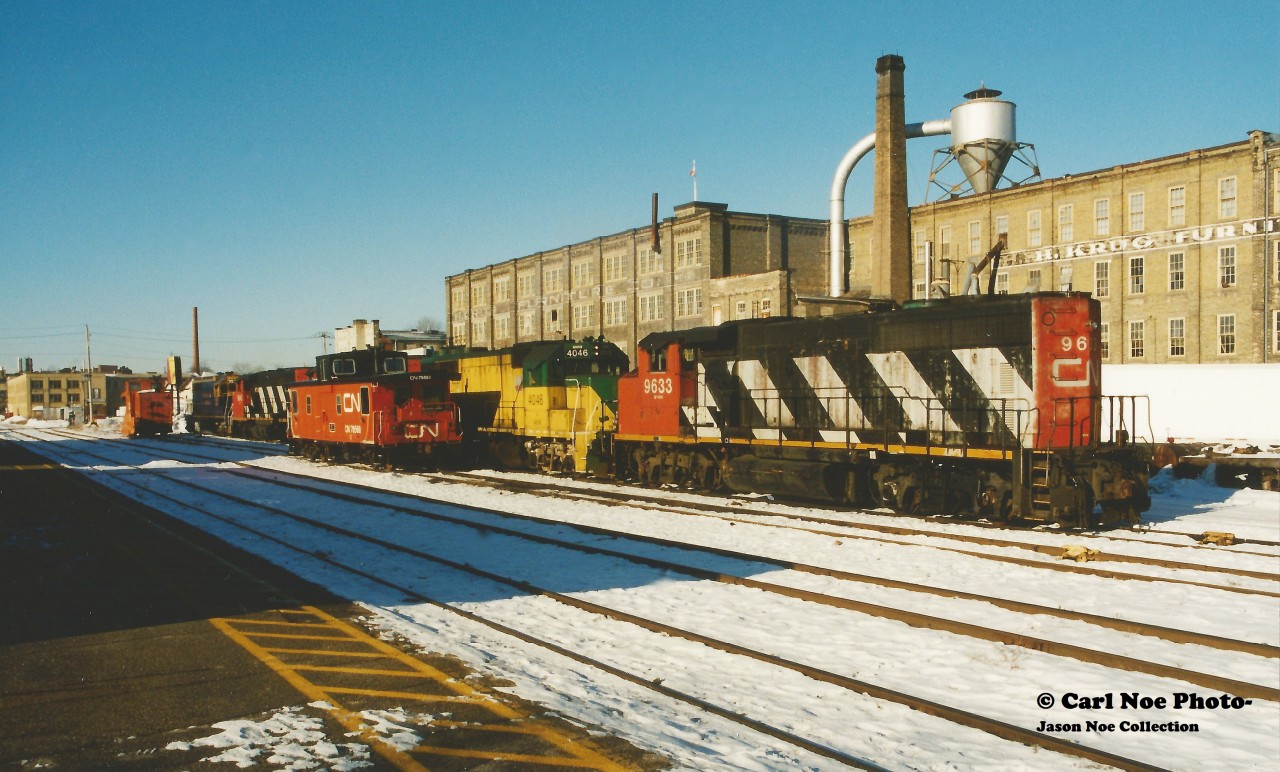 During the first couple months of the Goderich-Exeter Railway takeover of the CN Guelph Subdivision and related trackage, power-short GEXR had leased CN 9633, CN 9643 and CN 9661. On an early winter morning, all three CN units are seen along with NECR 9539 and GEXR 4046 in front of the Kitchener station along with GEXR's recently acquired former CN caboose.