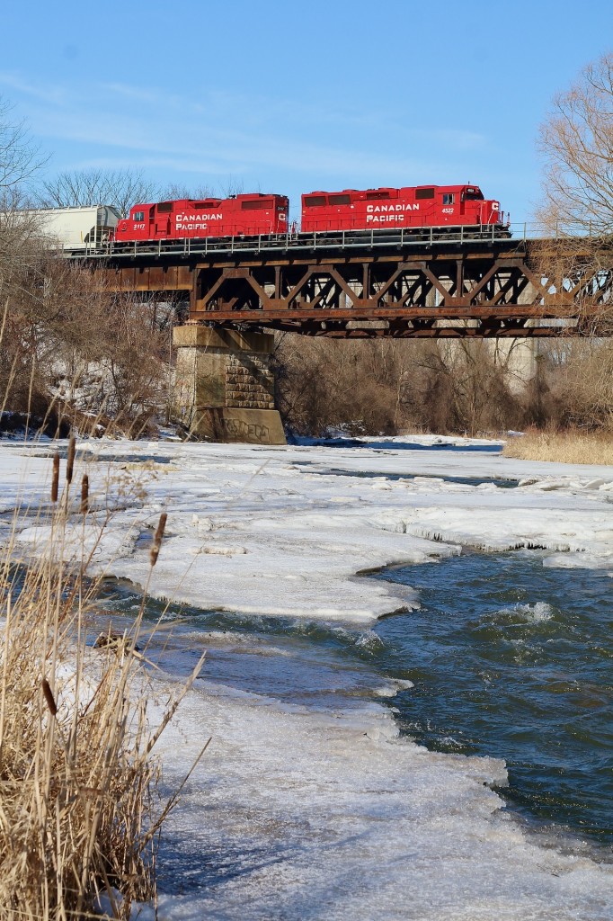 Last weeks deep freeze has finally began to take its grip off the frozen Credit River. While there is little signs of life other than some animal footprints in the snow, CP T14 certainly adds a splash of colour to the dormant landscape as somewhat unique former GP40X 4522 leads local T14 home to West Toronto.
