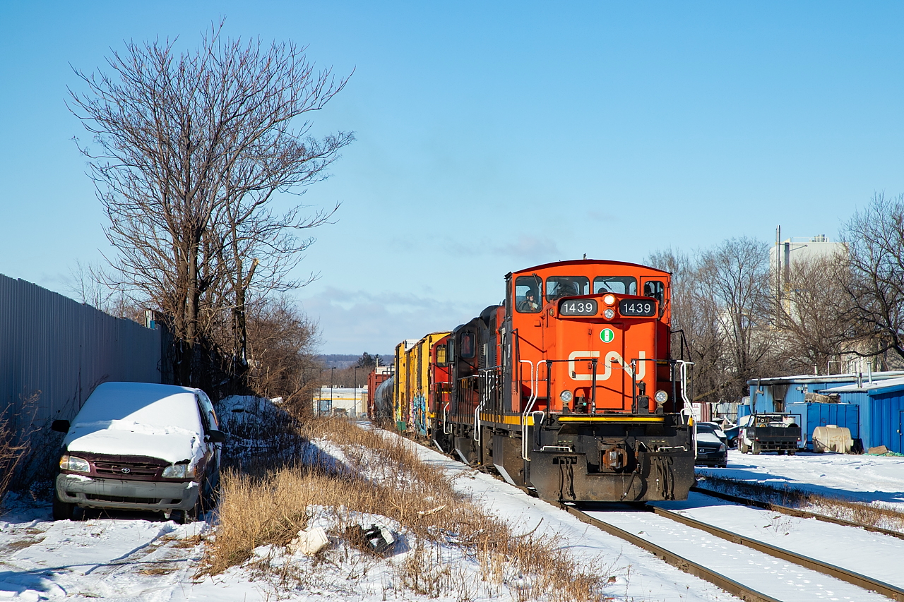The CN 0700 Yard Job heads eastbound on the N&NW Spur with cars for Parkdale Warehousing, Parkland, and Platinum Rail.