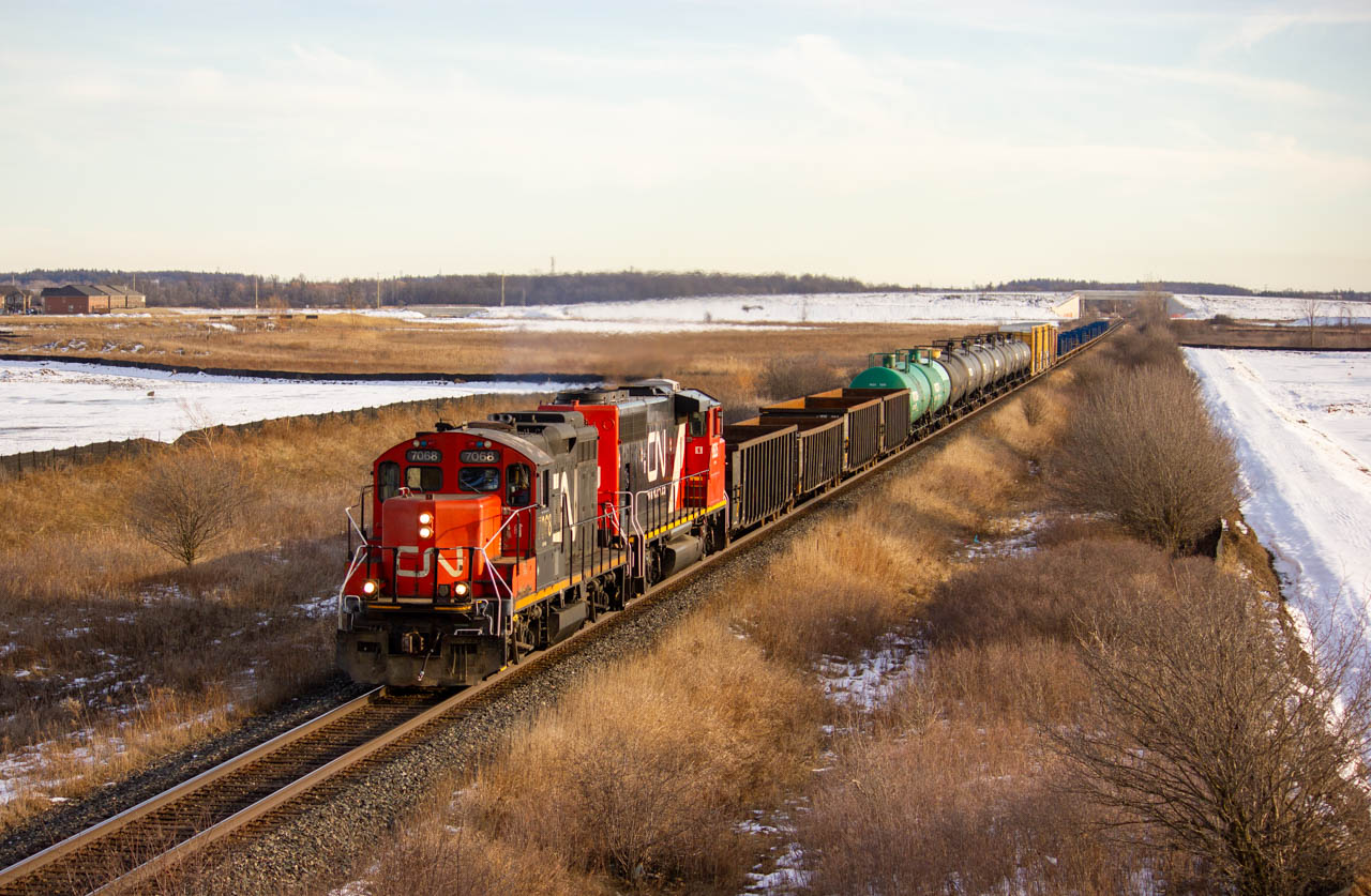 Just before the sun sets behind the Niagara Escarpment, CN 7068 & CN 9525 is hauling CN L551 eastward on the Halton Sub to service customers on the glass lead.