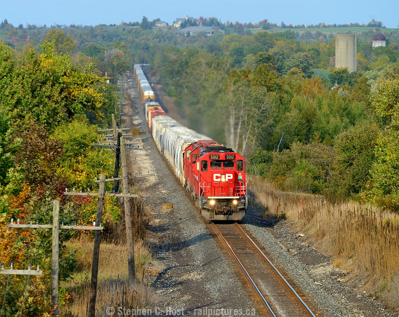 A nice after work train, about to duck under highway 6, CP 255 with a trio of EMD's is giving 'er for track speed to London. In the background is the bucolic Puslinch countryside.
